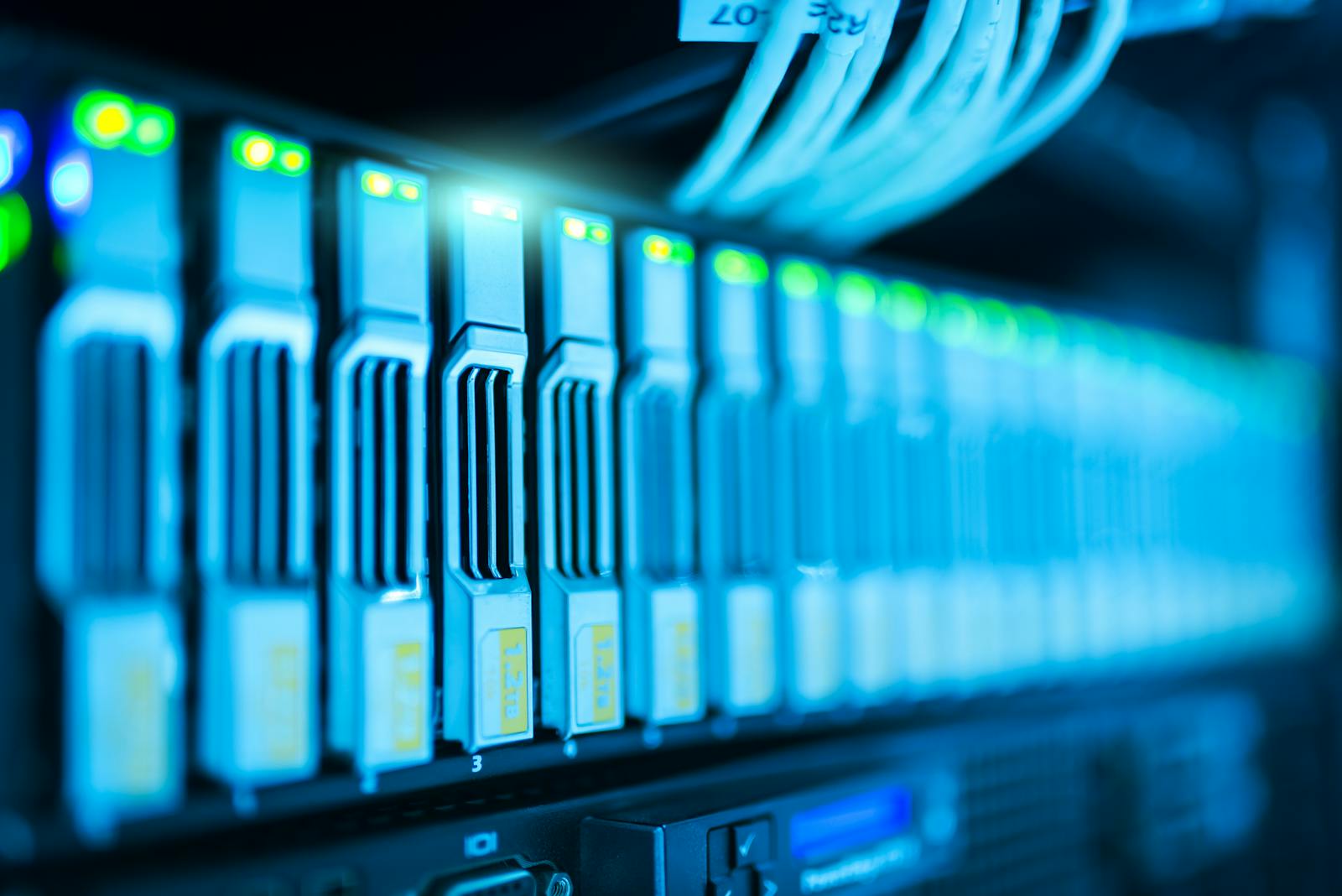 Photo by panumas nikhomkhai Detailed image of a server rack with glowing lights in a modern data center.